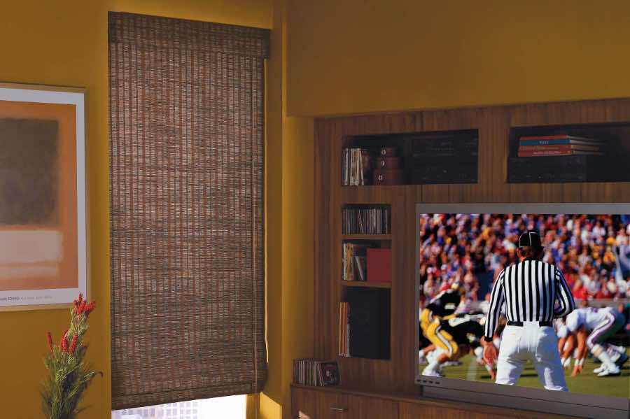Brown woven shade on a TV room window